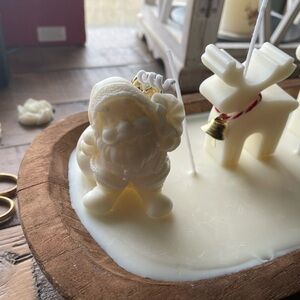 Adorable large candle with deers and santa . On white